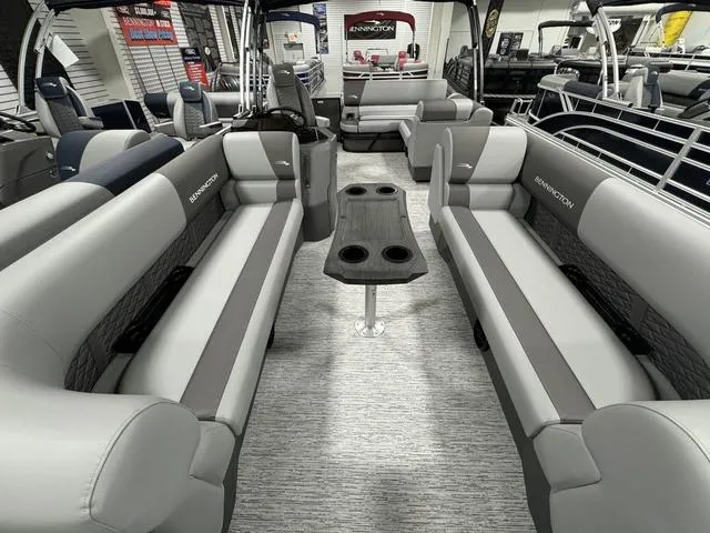 Slide: The Image of 2025 Bennington 23 SSB pontoon boat interior with gray seating and central table. - 13