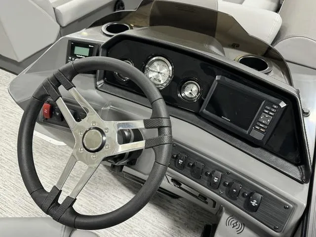 Slide: The Image of 2025 Bennington 23 SSB boat dashboard with steering wheel and gauges. - 14