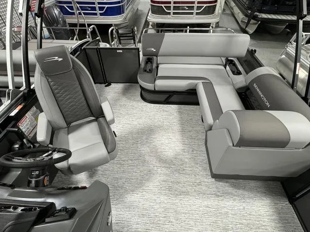 Slide: The Image of 2025 Bennington 23 SSB pontoon boat interior with gray seating and steering console. - 15