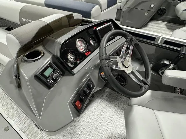 Slide: The Image of 2025 Bennington 23 SSB boat dashboard with steering wheel and control panel. - 16