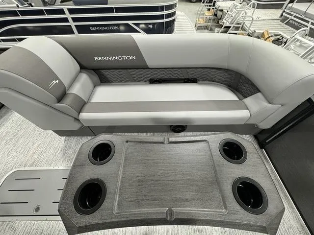 Slide: The Image of 2025 Bennington 23 SSB boat interior with gray seating and cup holders. - 21