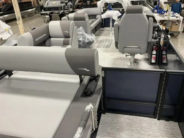 Slide: The Image of 2025 Bennington 23 SSB pontoon boat interior with gray seating and modern design. - 11