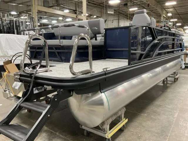 Slide: The Image of 2025 Bennington 23 SSB pontoon boat in a warehouse setting. - 4