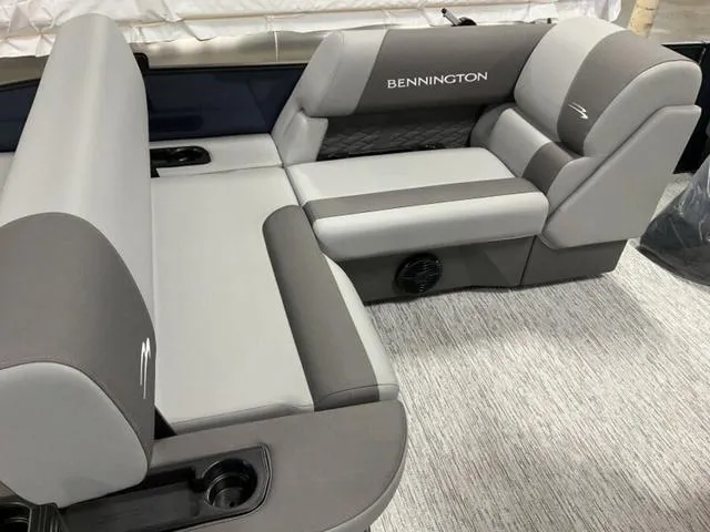 Slide: The Image of 2025 Bennington 23 SSB boat interior with gray seating and cup holders. - 7
