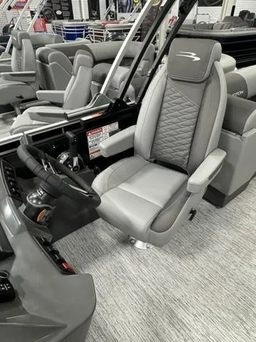 Slide: The Image of 2025 Bennington 22 SSR boat interior with modern gray captain's chair and steering console. - 12