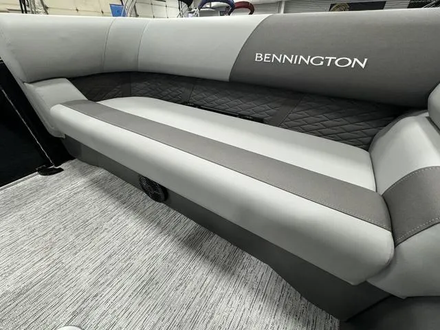 Slide: The Image of 2025 Bennington 22 SSR boat interior with gray cushioned seating and quilted backrest. - 14