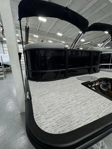 Slide: The Image of 2025 Bennington 22 SSR pontoon boat in showroom, featuring sleek design and modern finishes. - 22