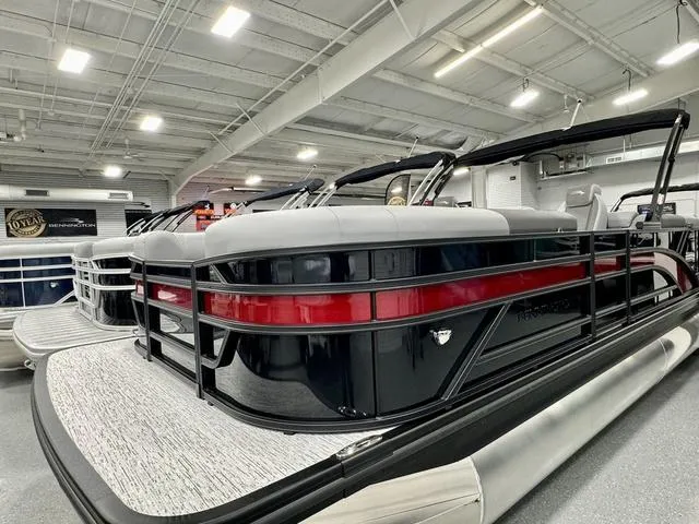 Slide: The Image of 2025 Bennington 22 SSR pontoon boat in showroom, featuring sleek black and red design. - 3