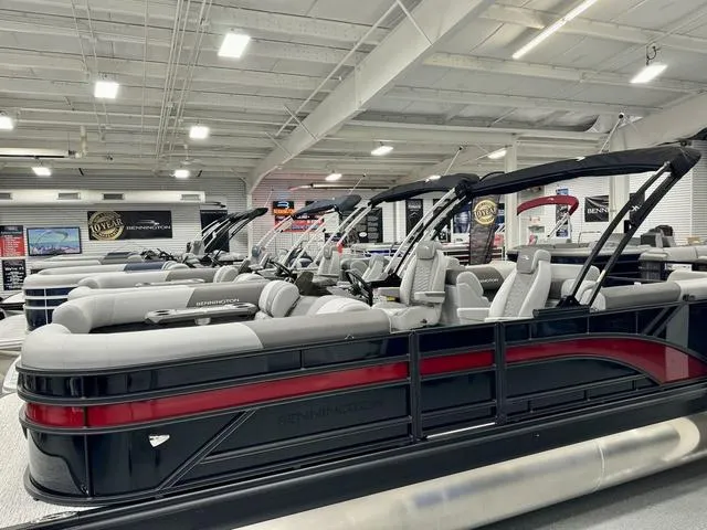 Slide: The Image of 2025 Bennington 22 SSR pontoon boats displayed in a showroom. - 7