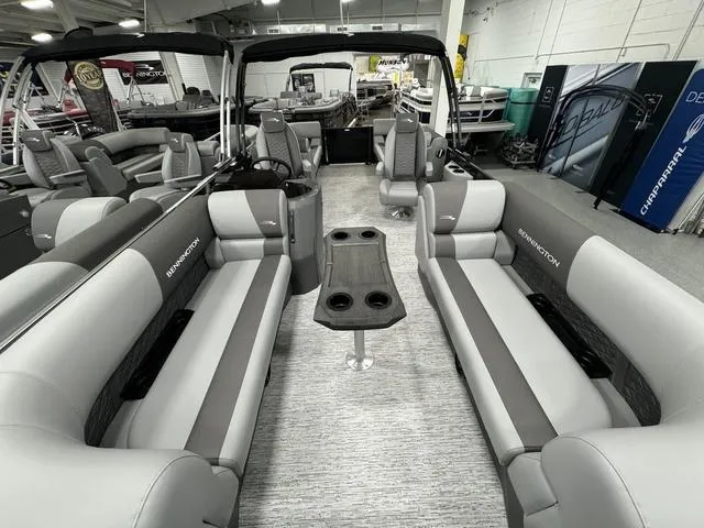 Slide: The Image of 2025 Bennington 22 SSR pontoon boat interior with gray seating and central table. - 8