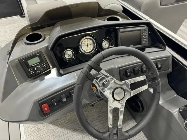 Slide: The Image of 2025 Bennington 22 SSR boat dashboard with steering wheel and control panel. - 9