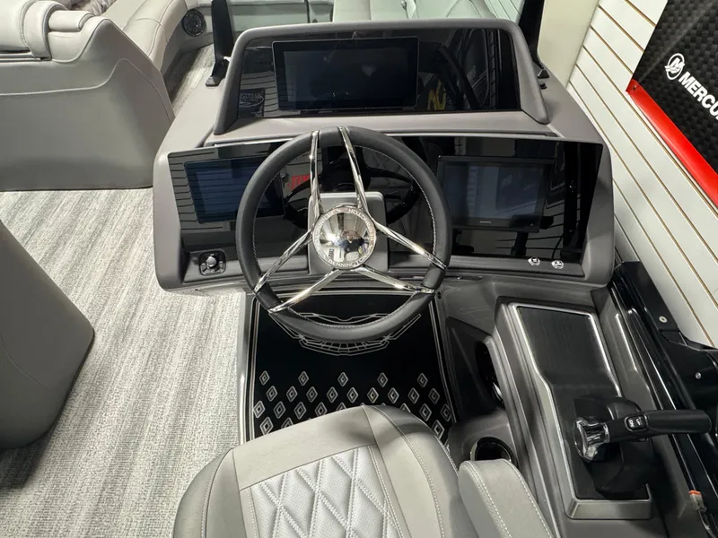 Slide: The Image of 2025 Bennington 25 RSB boat dashboard with modern steering wheel and digital displays. - 10