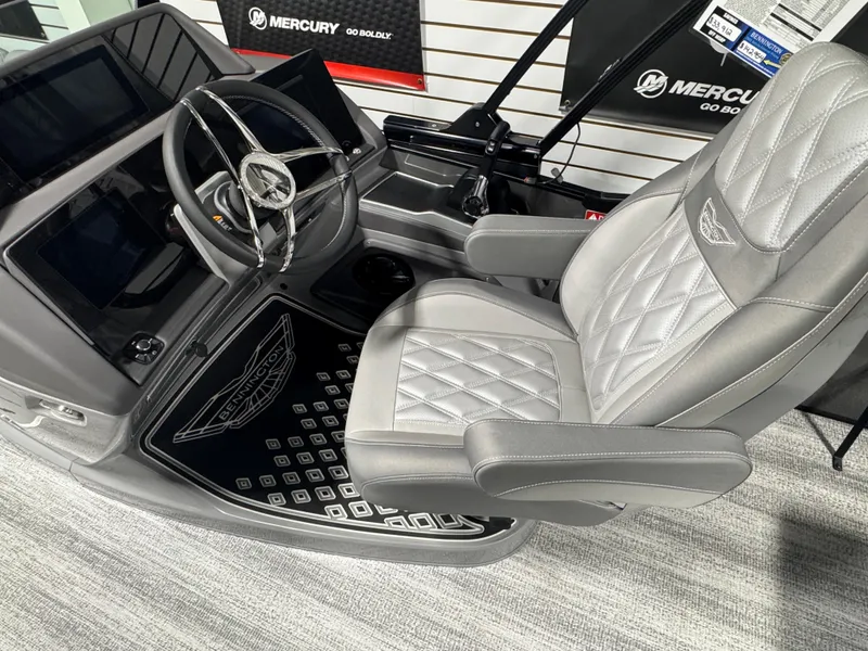 Slide: The Image of Captain's seat and helm of 2025 Bennington 25 RSB boat with Mercury controls. - 11