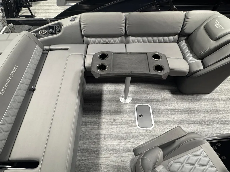Slide: The Image of Luxurious seating area on 2025 Bennington 25 RSB pontoon boat with gray upholstery and cup holders. - 12