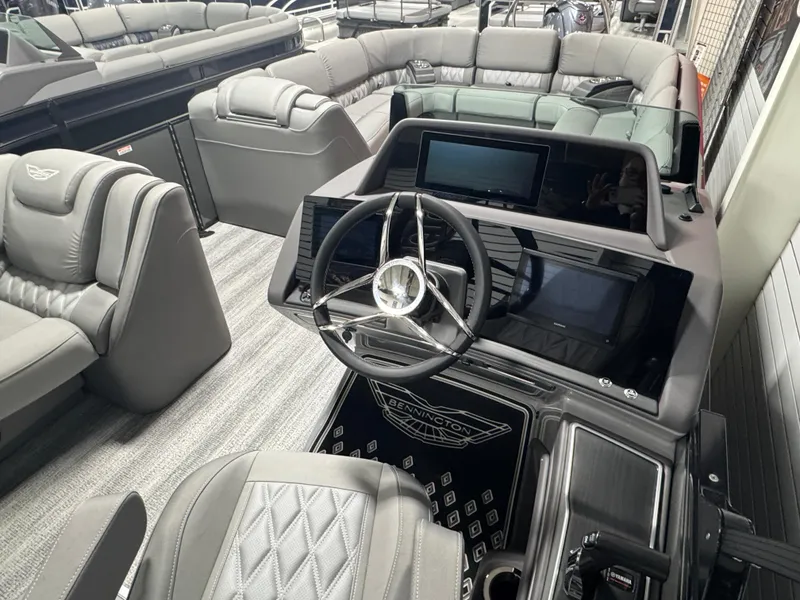 Slide: The Image of Interior of 2025 Bennington 25 RSB boat with modern steering and luxurious seating. - 13