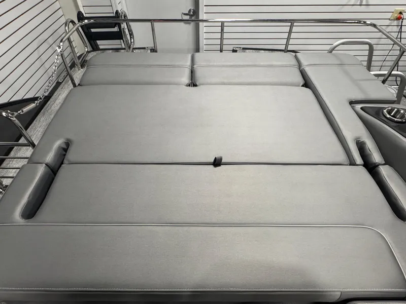 Slide: The Image of 2025 Bennington 25 RSB boat interior with sleek gray seating and cup holder. - 16