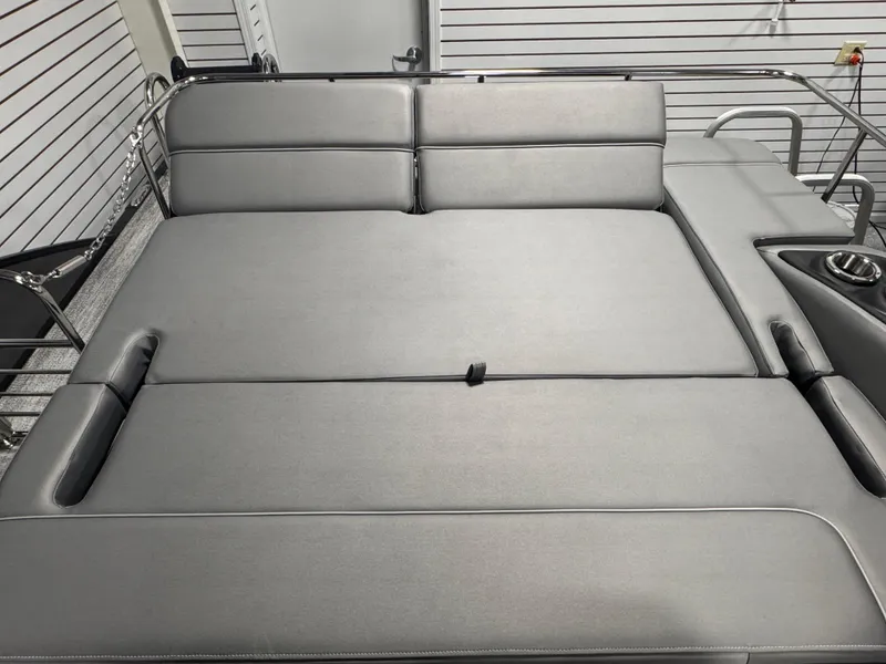 Slide: The Image of 2025 Bennington 25 RSB boat interior with gray cushioned seating and cup holder. - 18