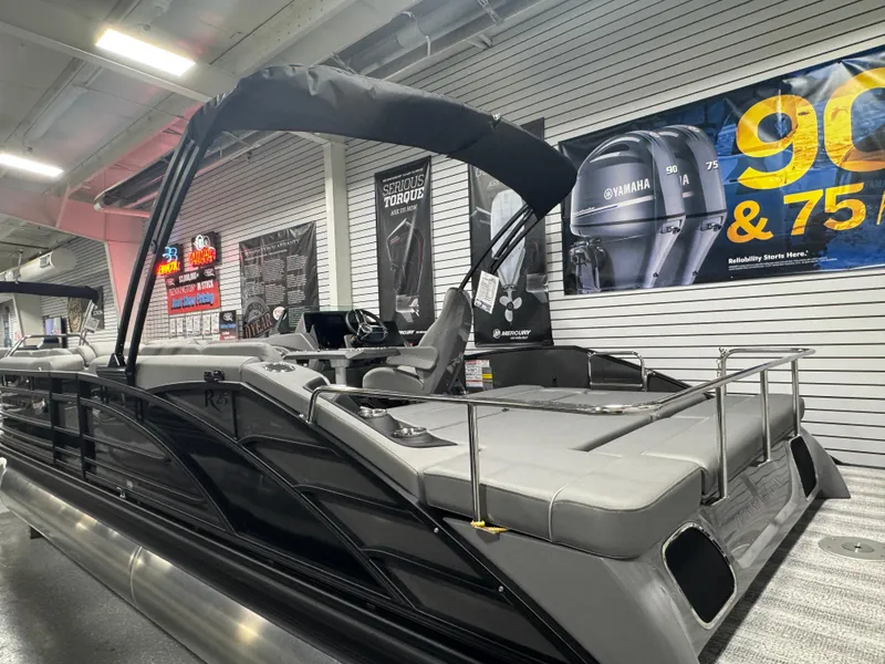 Slide: The Image of 2025 Bennington 25 RSB pontoon boat displayed indoors, featuring sleek design and modern amenities. - 21