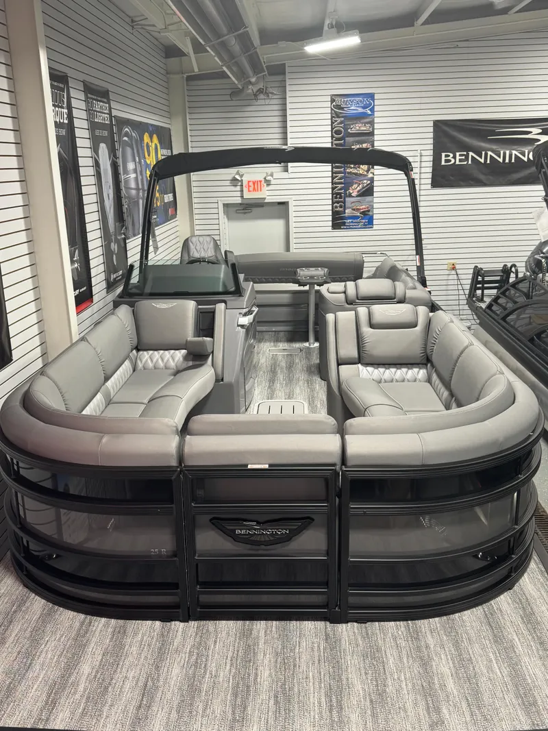 Slide: The Image of 2025 Bennington 25 RSB pontoon boat with luxurious seating in a showroom. - 4