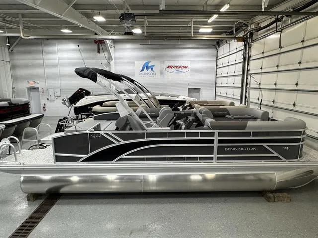 The Image of 2025 Bennington 22 SSB pontoon boat in a warehouse setting. - 1