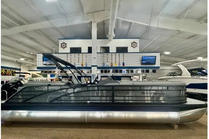 The Image of 2025 Bennington 25 RFBSE pontoon boat displayed in a showroom. - 0