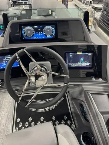 Slide: The Image of 2025 Bennington 25 RFBSE pontoon boat interior with luxurious gray seating and cup holders. - 10