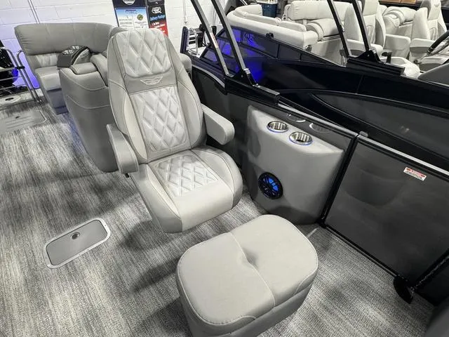 Slide: The Image of 2025 Bennington 25 RFBSE boat interior with luxurious gray seating and modern dashboard. - 19