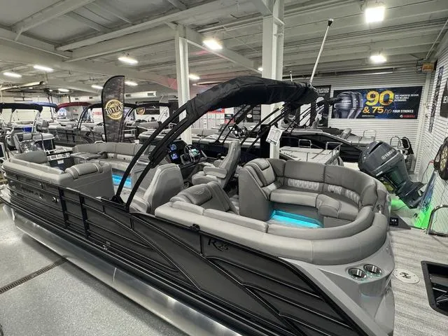 Slide: The Image of 2025 Bennington 25 RFBSE boat with outboard motor in showroom display. - 23