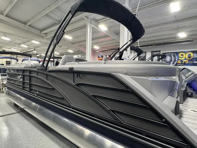 Slide: The Image of 2025 Bennington 25 RFBSE pontoon boat with luxurious seating and modern design in showroom. - 4