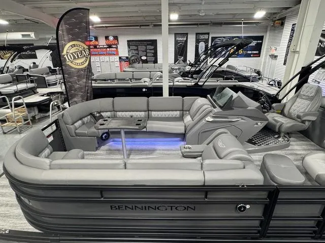 Slide: The Image of 2025 Bennington 25 RFBSE pontoon boat interior with modern seating and control panel. - 7
