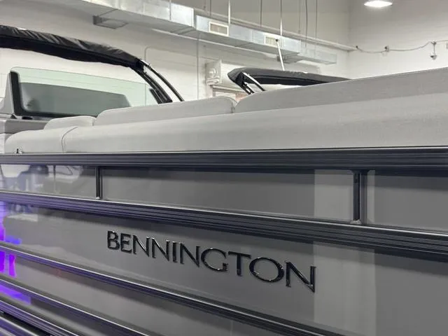 Slide: The Image of Luxurious interior of 2025 Bennington 25 RFBSE pontoon boat with gray seating and green LED lighting. - 8