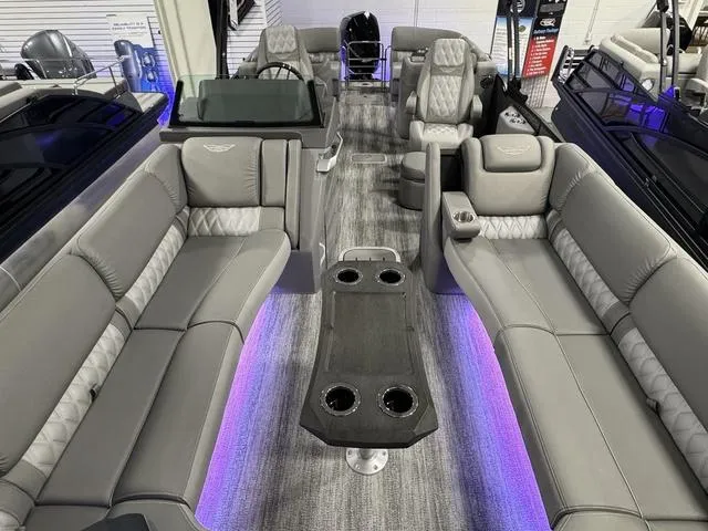 Slide: The Image of 2025 Bennington 25 RFBSE pontoon boat interior with luxurious gray seating and ambient lighting. - 9