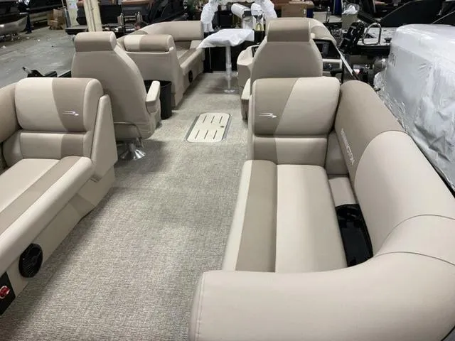 Slide: The Image of 2025 Bennington 22 SSR pontoon boat interior with beige seating and carpeted flooring. - 3