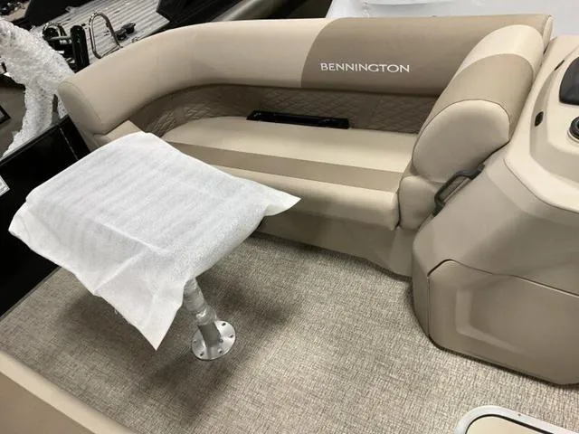 Slide: The Image of 2025 Bennington 22 SSR boat interior with beige seating and table. - 7