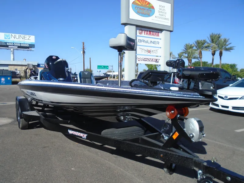 Slide: The Image of 2025 Phoenix 819 ZXL boat on trailer in dealership lot. - 2