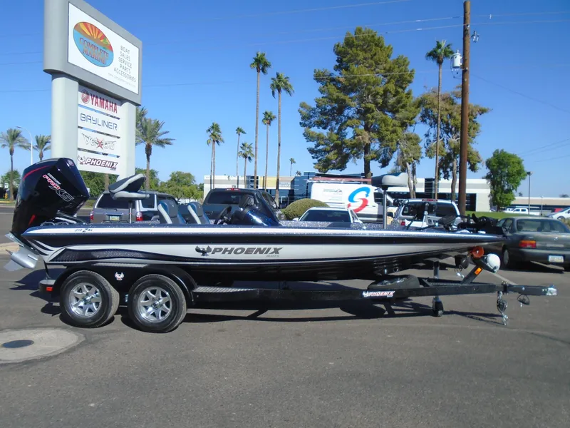 Slide: The Image of 2025 Phoenix 819 ZXL boat on trailer, parked outdoors near dealership. - 8