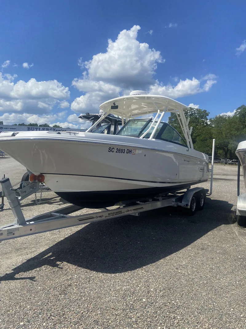 Slide: The Image of 2018 Boston Whaler 230 Vantage on trailer under blue sky. - 11