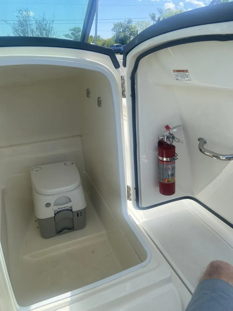 Slide: The Image of Interior of 2018 Boston Whaler 230 Vantage with toilet and fire extinguisher. - 14