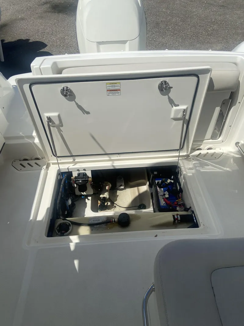 Slide: The Image of 2018 Boston Whaler 230 Vantage storage compartment with open hatch. - 16