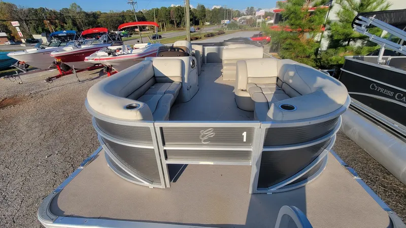 Slide: The Image of 2020 Cypress Cay Seabreeze 232 pontoon boat with spacious seating, parked outdoors. - 6