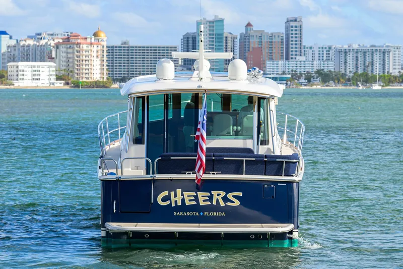 Slide: The Image of 2023 Sabre 48 Salon Express yacht on water, Sarasota, Florida skyline in background. - 11