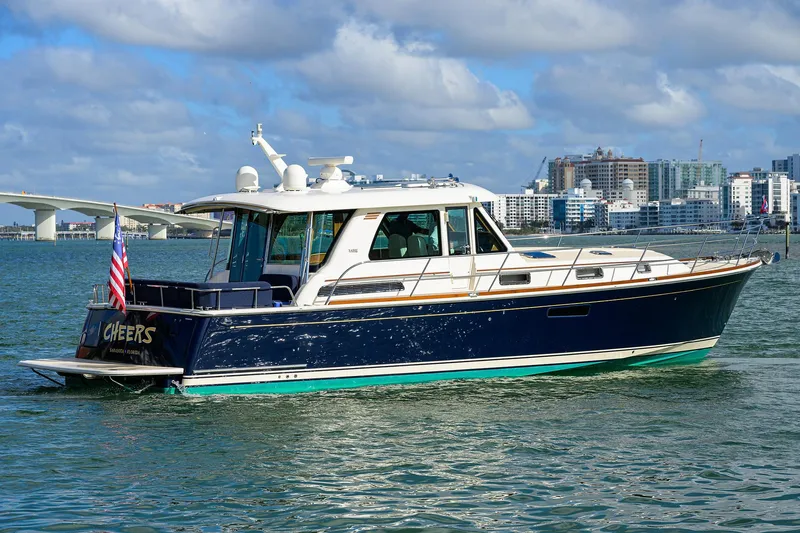 Slide: The Image of 2023 Sabre 48 Salon Express yacht cruising in a scenic harbor. - 12