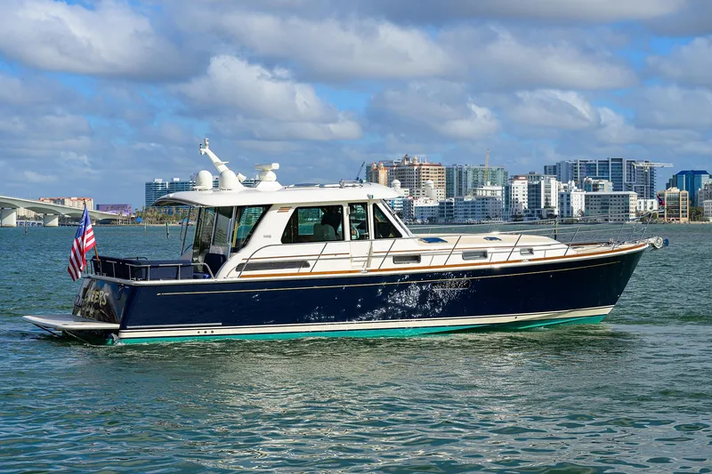 Slide: The Image of 2023 Sabre 48 Salon Express yacht cruising near city skyline. - 13