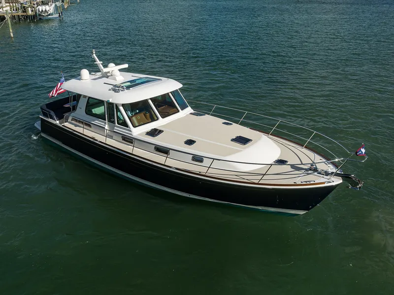 Slide: The Image of 2023 Sabre 48 Salon Express yacht on calm water, showcasing sleek design and luxury features. - 16