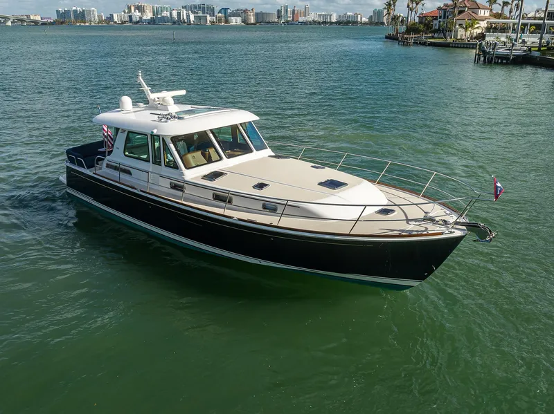 Slide: The Image of 2023 Sabre 48 Salon Express yacht cruising on a scenic waterway. - 17