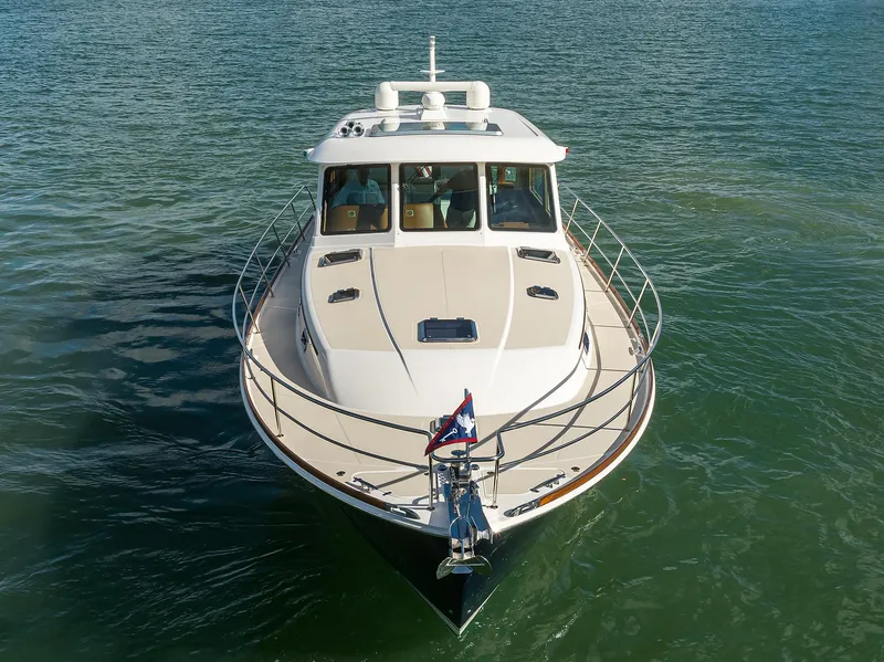 Slide: The Image of 2023 Sabre 48 Salon Express yacht on calm water, front view. - 18