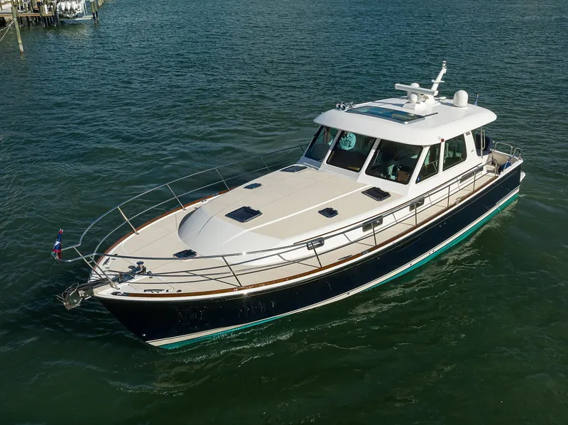 Slide: The Image of 2023 Sabre 48 Salon Express yacht cruising on calm waters. - 21