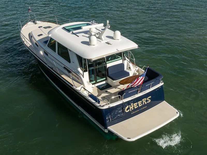 Slide: The Image of 2023 Sabre 48 Salon Express yacht cruising on open water, rear view. - 24