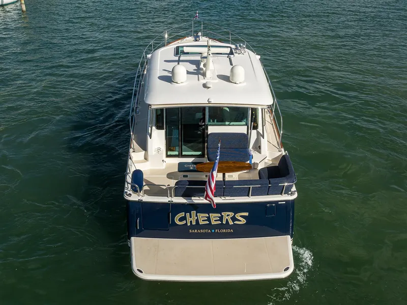 Slide: The Image of 2023 Sabre 48 Salon Express yacht on water, rear view with "Cheers" name. - 25