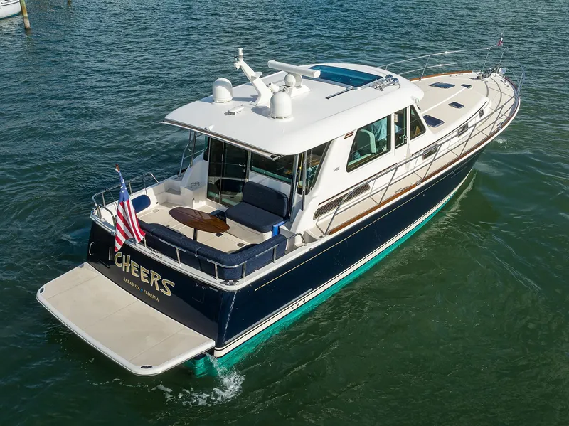 Slide: The Image of 2023 Sabre 48 Salon Express yacht cruising on water with American flag. - 26